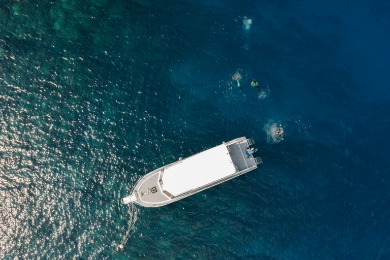 Boat in clear blue ocean near Roatan beach