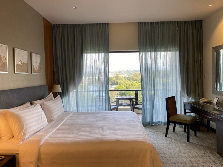 comfortable-hotel-bedroom-with-a-balcony-view